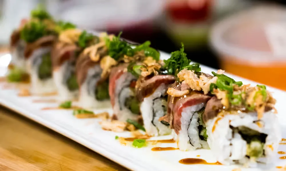 Beef carpaccio roll topped with seared beef and fresh greens at Meal Set Bistro | Sushi, Winnipeg