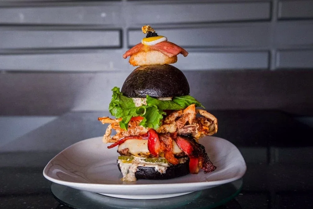 Stacked bao burger with crispy filling and fresh garnish at Meal Set Bistro | Sushi, River Heights Winnipeg