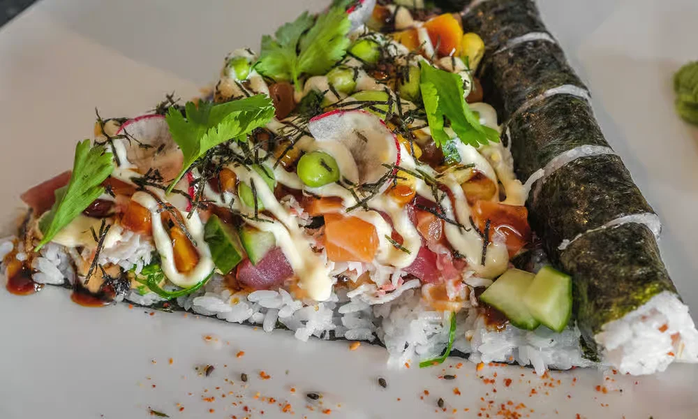 Deluxe sushi pizza slice with crispy rice, fresh fish and nori at Meal Set Bistro | Sushi, Academy Road Winnipeg